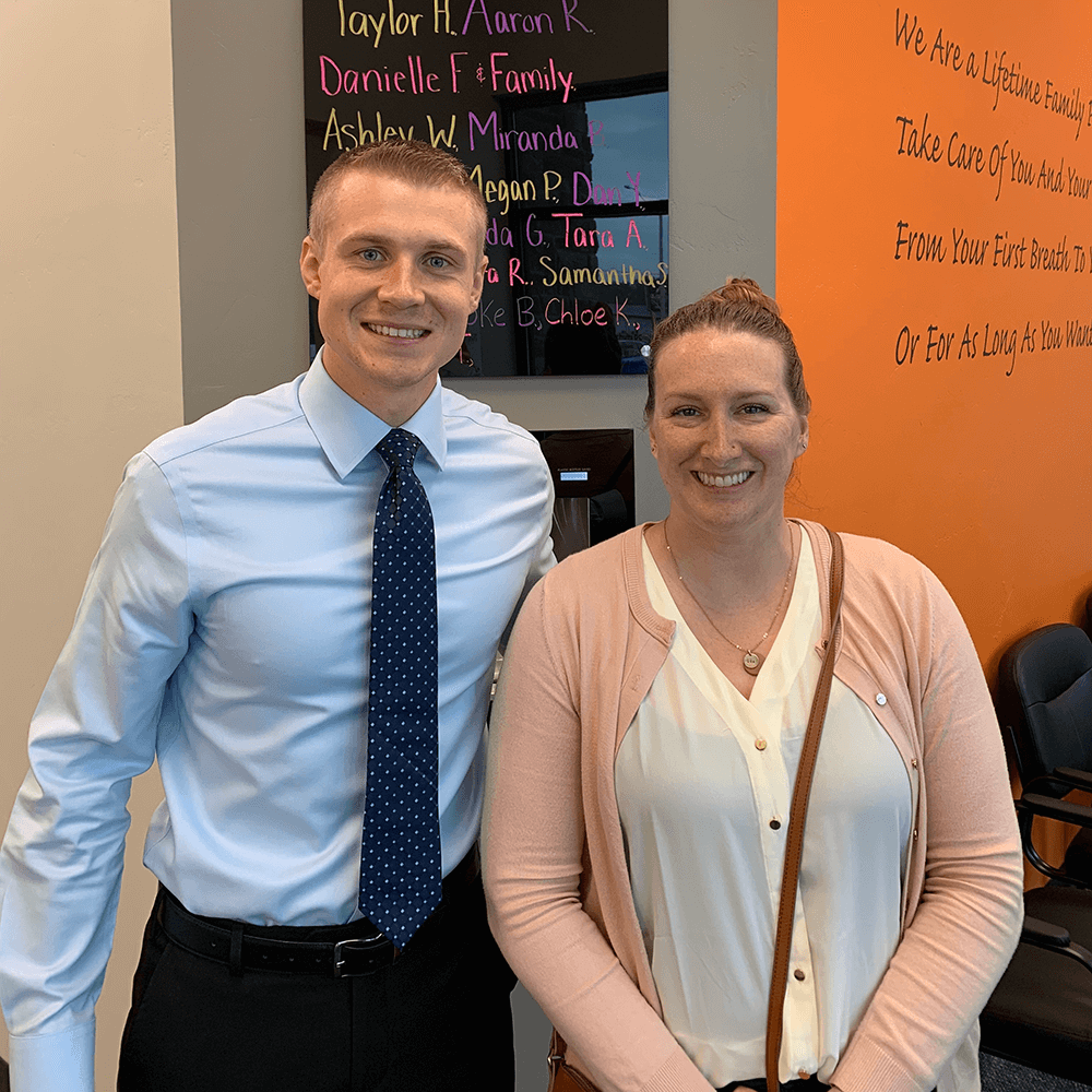 chiropractor smiling with a patient inside his chiropractic care office