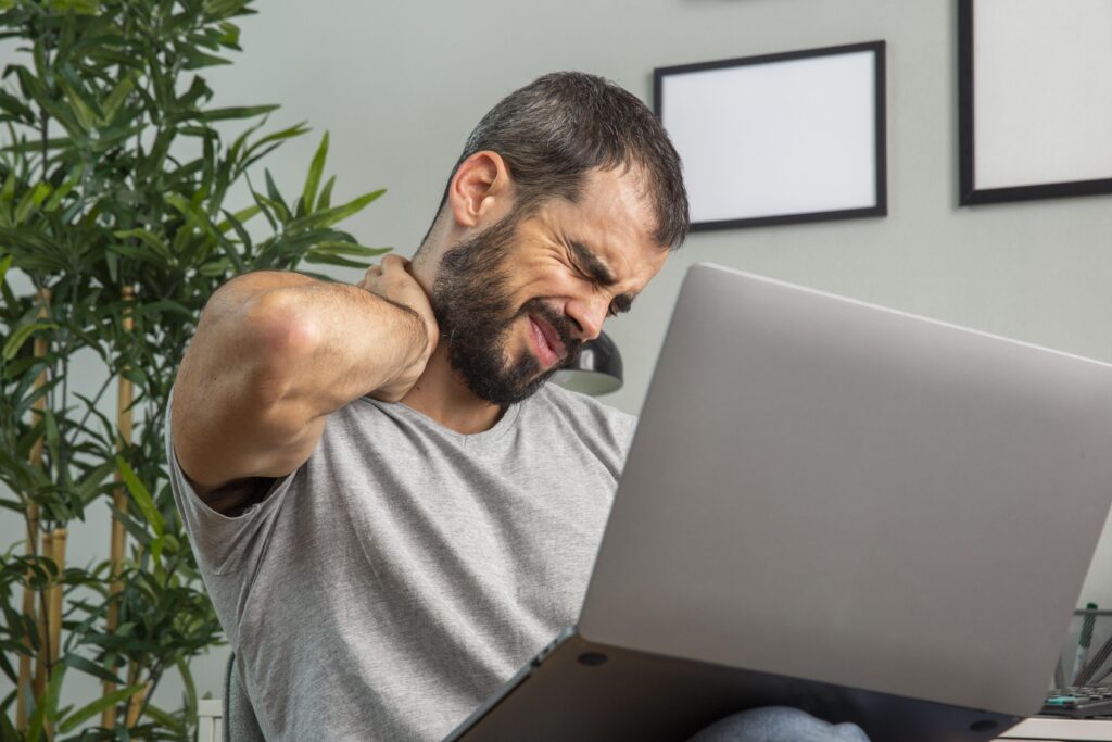 man holding his neck pain